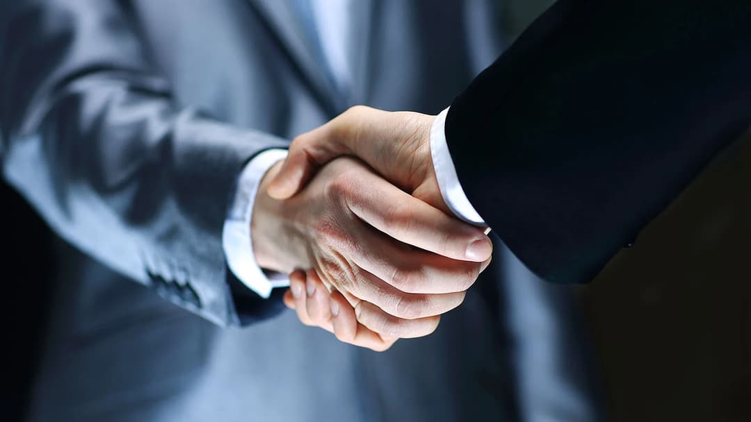 Business partnership handshake